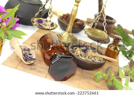 Chinese medicine with plants and scale on a light background