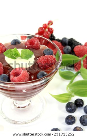 red fruit jelly with vanilla and lemon balm on a light background