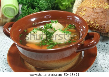 Marrow soup with fresh parsley, vegetables and rolls