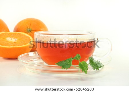 Orange tea with fresh oranges and lemon balm