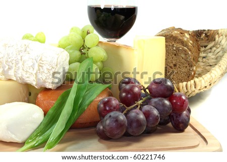 Cheese with fresh grapes, tomatoes and red wine