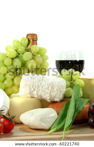 Cheese with fresh grapes, tomatoes and red wine