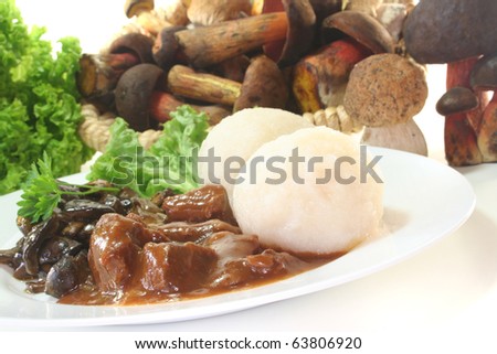 Game goulash with dumplings and fresh mushrooms