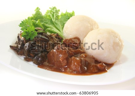 Game goulash with dumplings and fresh mushrooms