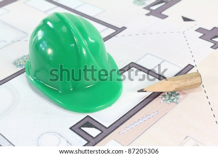 green construction helmet with a pencil and sketch