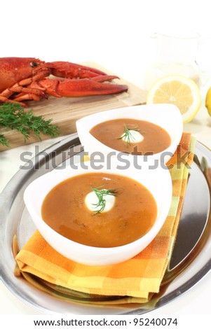 freshly cooked lobster soup with lemon, dill and cream dollop