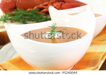 boiled lobster soup with lemon, dill and cream dollop