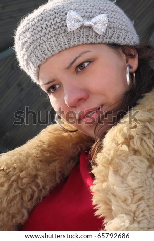 portrait of the beautiful young woman in winter clothes