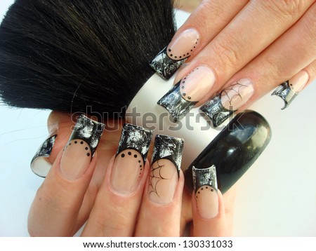 closeup of elegant Halloween nail art design pattern manicure with black and white foils and spider web