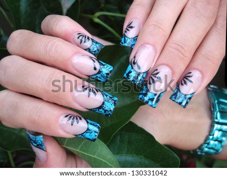 beautiful female hands with amazing turquoise foil gel french nail art design manicure with free hand drawn pattern