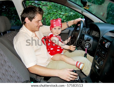 Father and daughter at the wheel. Learning to drive and having fun.