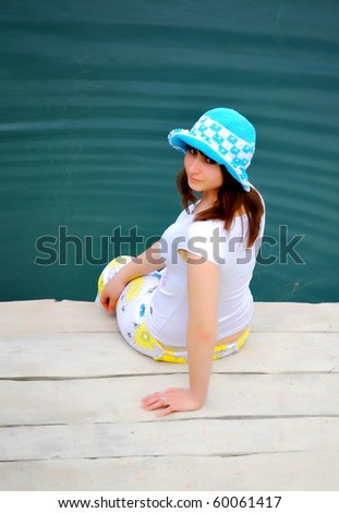 Young girl dabble in water by lake