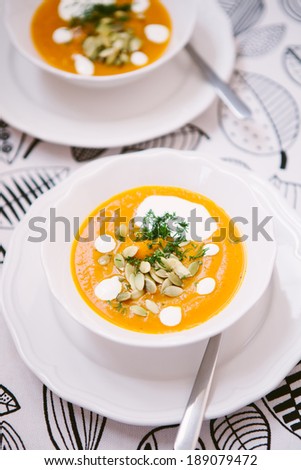 Pumpkin soup with sour cream, dill and pumpkin seeds