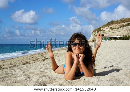 Young active woman on a beach in Sea