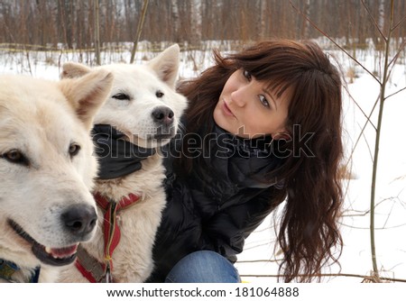 Young woman and dogs siberian husky on snow, winter