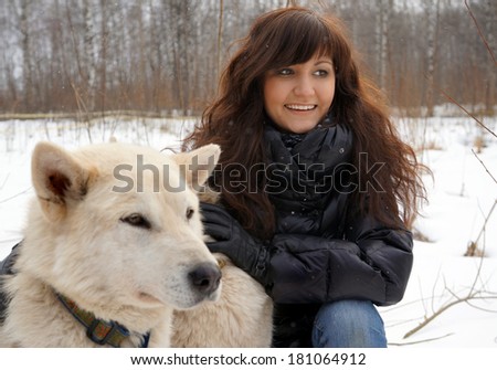 Young woman and dogs siberian husky on snow, winter
