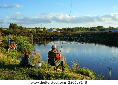 KOSTROMA, RUSSIA -  SEPTEMBER 5, 2014: Sports competitions on fishing on catching of a carp and a sturgeon, Kostroma, Russia at september 5, 2014. Fishermen on lake with fishing tackles