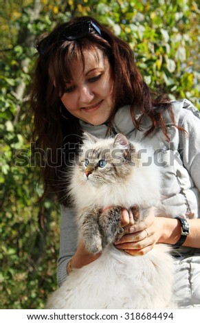 Siberian nevsky masqarade cat and young woman in a  autumn nature