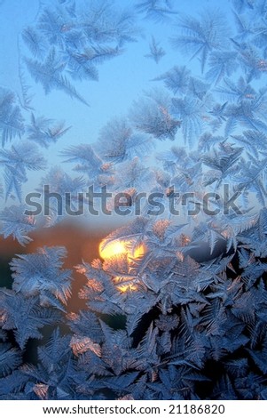 Frosty pattern on window. Sunset