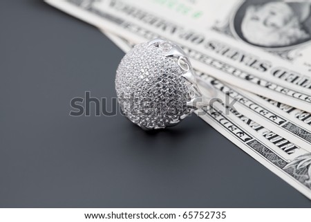 American dollars. Bundle of bank notes and brilliant ring