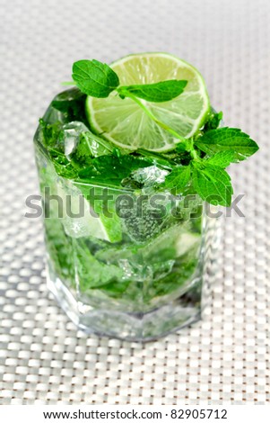 Alcoholic beverage of lime and mint in glass - Mochito