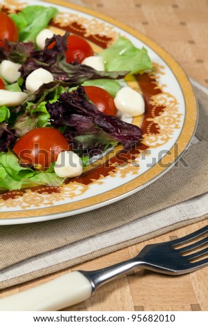 Food - plate with italian salad with mozarella on a table