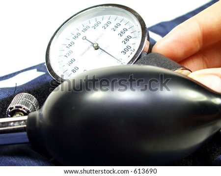 Blood pressure cuff with hand holding pressure meter all isolated on white.