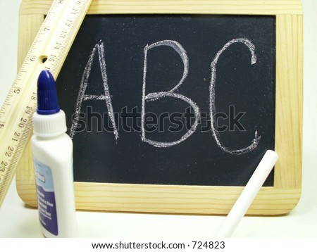 Chalk board, chalk, glue and ruler isolated on white with A B C written on chalk board.