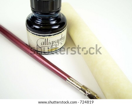 A bottle of ink, a roll of parchment that , and calligraphy pen shot isolated on white.