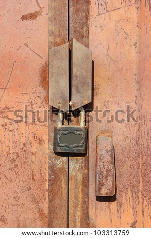 Rusty vintage lock on old garage gate