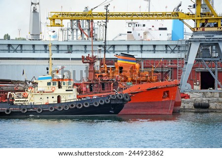 Bunker ship and tugboat under port crane, Odessa, Ukraine