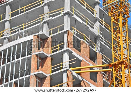 Crane and building construction site with balcony