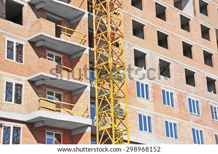 Crane and building construction site with balcony