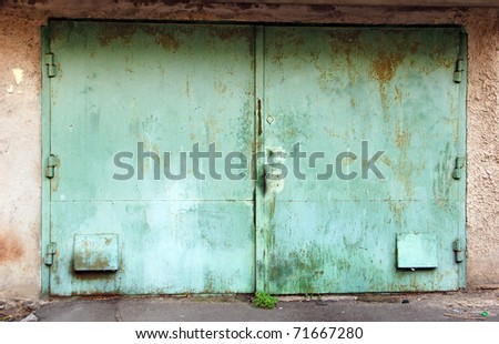 Old dirty green steel double garage gate