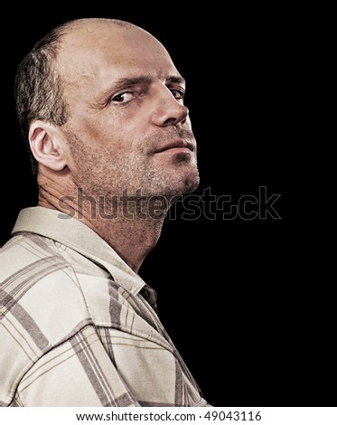 Portrait of thin unshaven man isolated on black