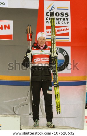 SZKLARKA POREBA, POLAND - FEBRUARY 17: American Cross Country Skier Kikkan Randall on the podium of Cross Country World Cup on February 17, 2012 in Szklarska Poreba, Poland
