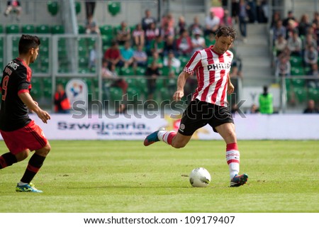 WROCLAW, POLAND - JULY 22: Final game in Polish Masters soccer tournament between PSV Eindhoven and Benfica Lisboa 3:1with Mark van Bommel from PSV (right) on July 22, 2012 in Wroclaw, Poland