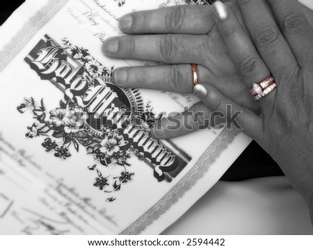 hands with marriage certificate