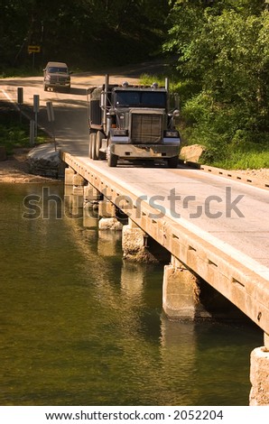 Truck crossing one lane bridge