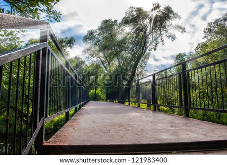 passage into the park through the old bridge