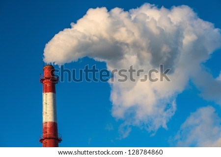 Factory pipe produces smoke in the sky
