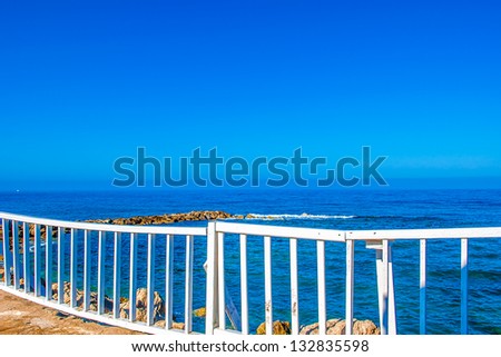 white wooden rail fencing from the precipice into the sea