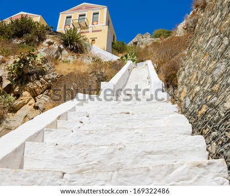 white stone staircase leading up the hill to the house