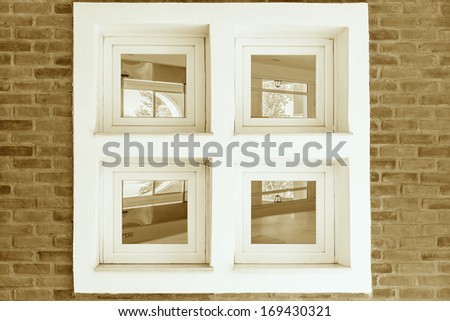 window in an old brick wall with a view inside the interior