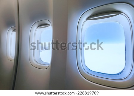 airplane porthole view into open space sky