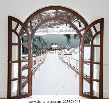 open door arch access to the stairs down winter covered with snow