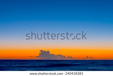 beautiful sunrise sun in the clouds on a quiet calm sea