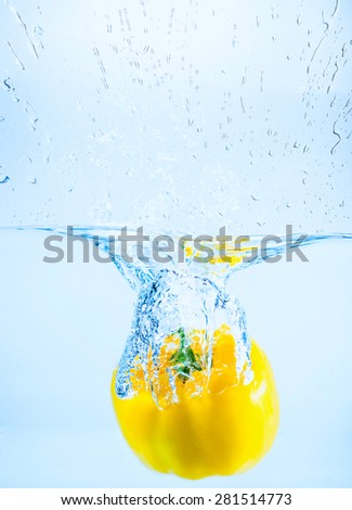 sweet pepper falling in water with splashes and drops