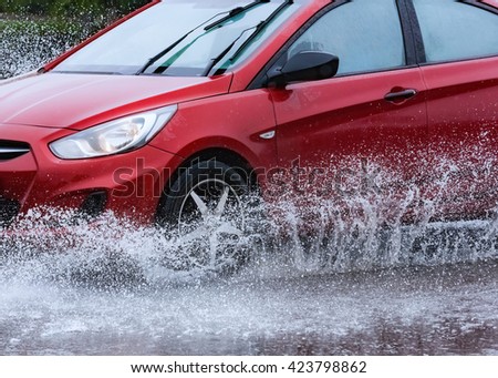motion car rain big puddle of water spray from the wheels