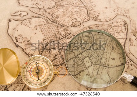 Modern compass old map and magnifier
